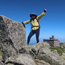 Marion on top of Cherny Vrah with its mountain hut in the back